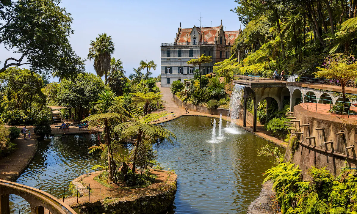 Terraced hillside gardens of Monte Palace in Funchal Madeira with exotic tropical plants and panoramic view of Atlantic Ocean harbor below, botanical island photography