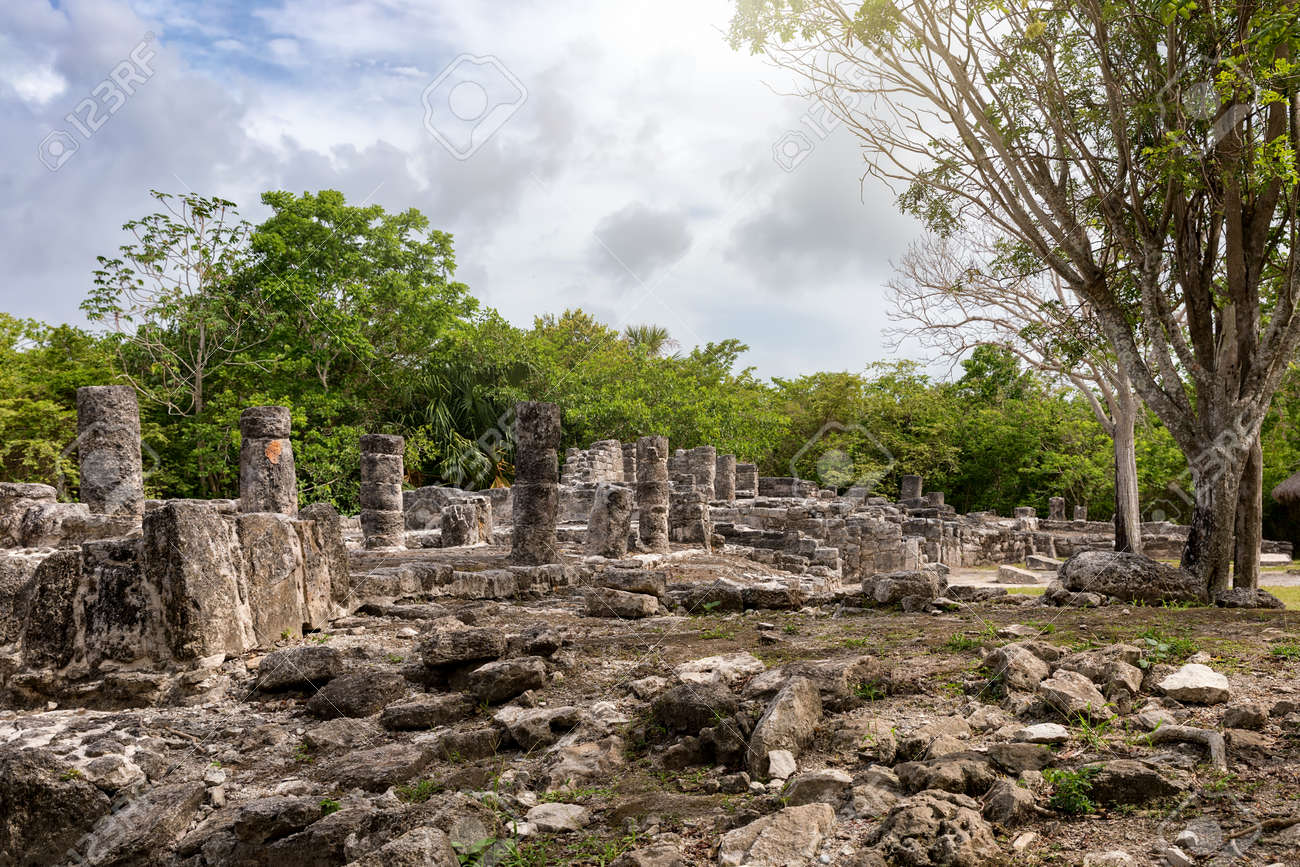 Ancient Mayan stone ruins at San Gervasio on Cozumel island surrounded by tropical vegetation under bright Caribbean sunlight, archaeological travel photography