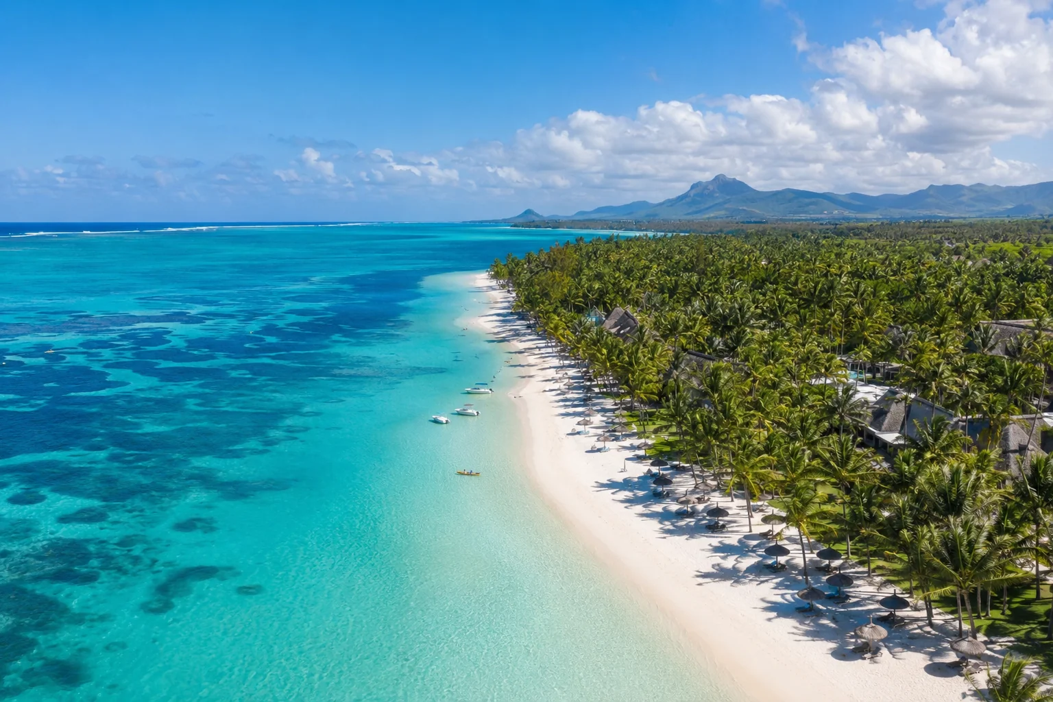 Le Morne Brabant mountain rising above turquoise Mauritius lagoon with white sand beach and clear sky, dry season travel photography
