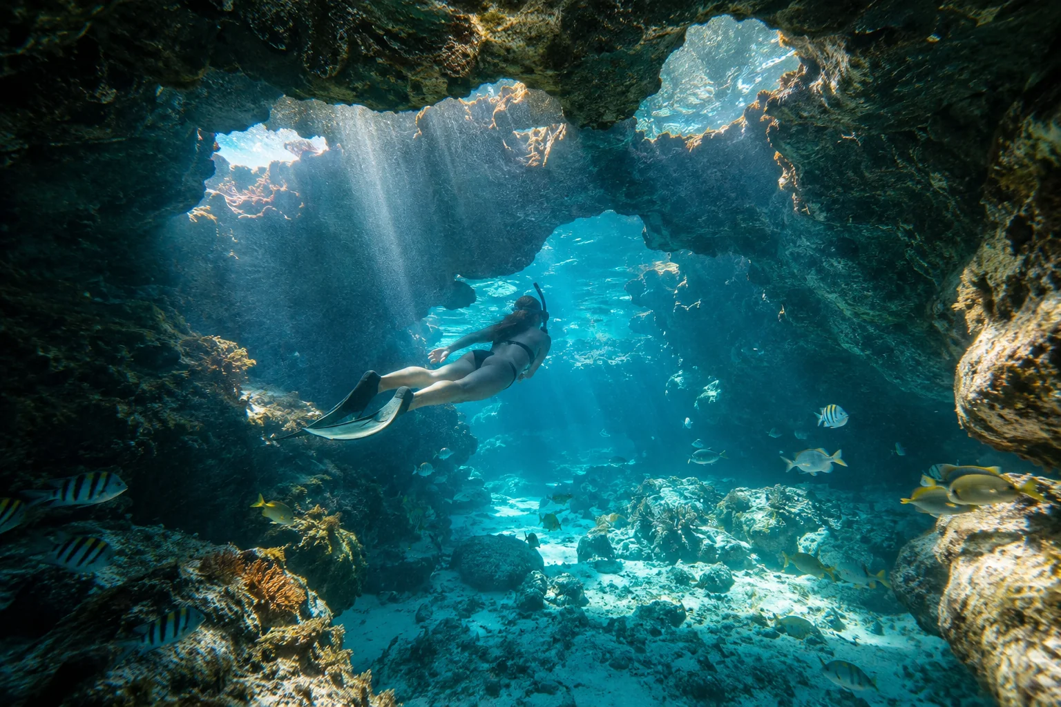 Aerial view of Exuma Cays chain stretching across turquoise Bahamas water with white sandbars and uninhabited green islands, bright tropical light, travel aerial photography