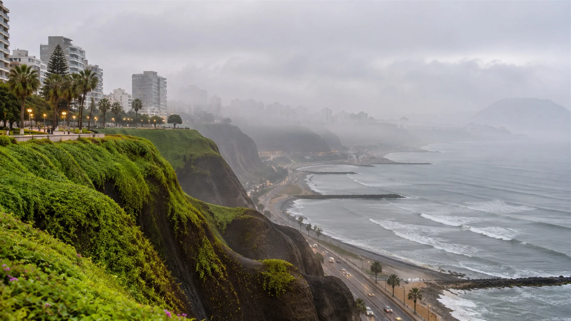 Lima coastal cliffs above the Pacific Ocean wrapped in soft grey winter mist with ocean waves below, muted overcast light, atmospheric travel photography