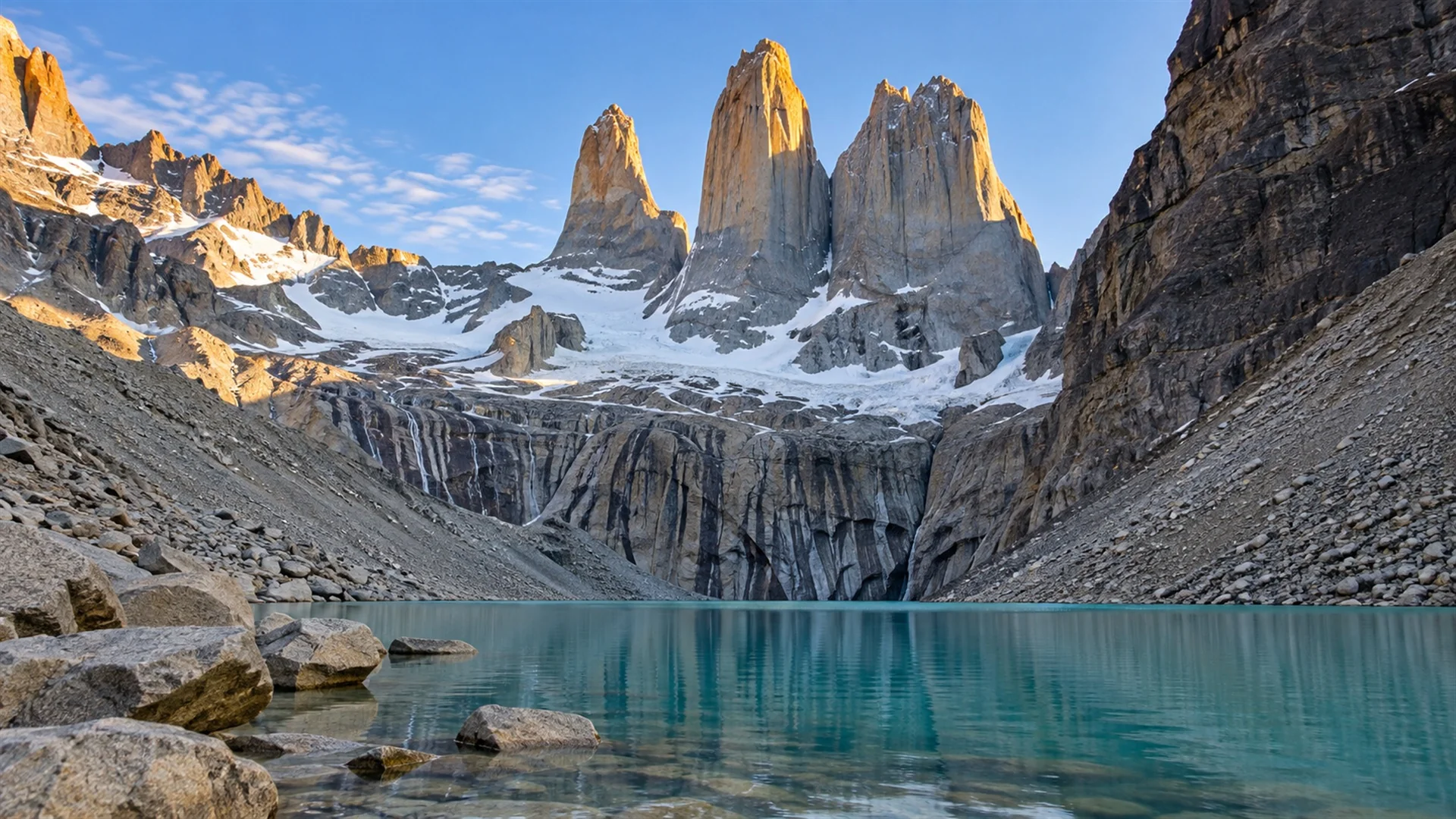 Torres del Paine luxury travel — granite towers of the Paine Massif above a turquoise lake in morning light, editorial Patagonia landscape photography