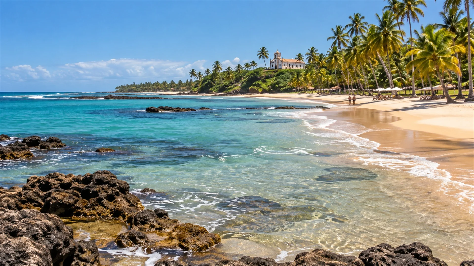 Best time to visit Brazil — Bahia coastline with palm trees, turquoise water and golden sand under a clear dry-season sky, editorial travel photography