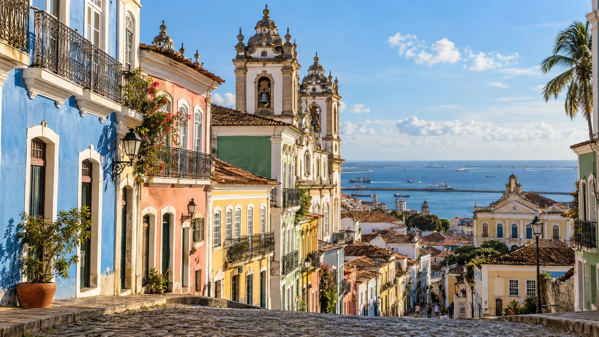 Colonial facades of Salvador's historic center in bright afternoon light with colorful buildings and cobbled streets above the bay, editorial travel photography