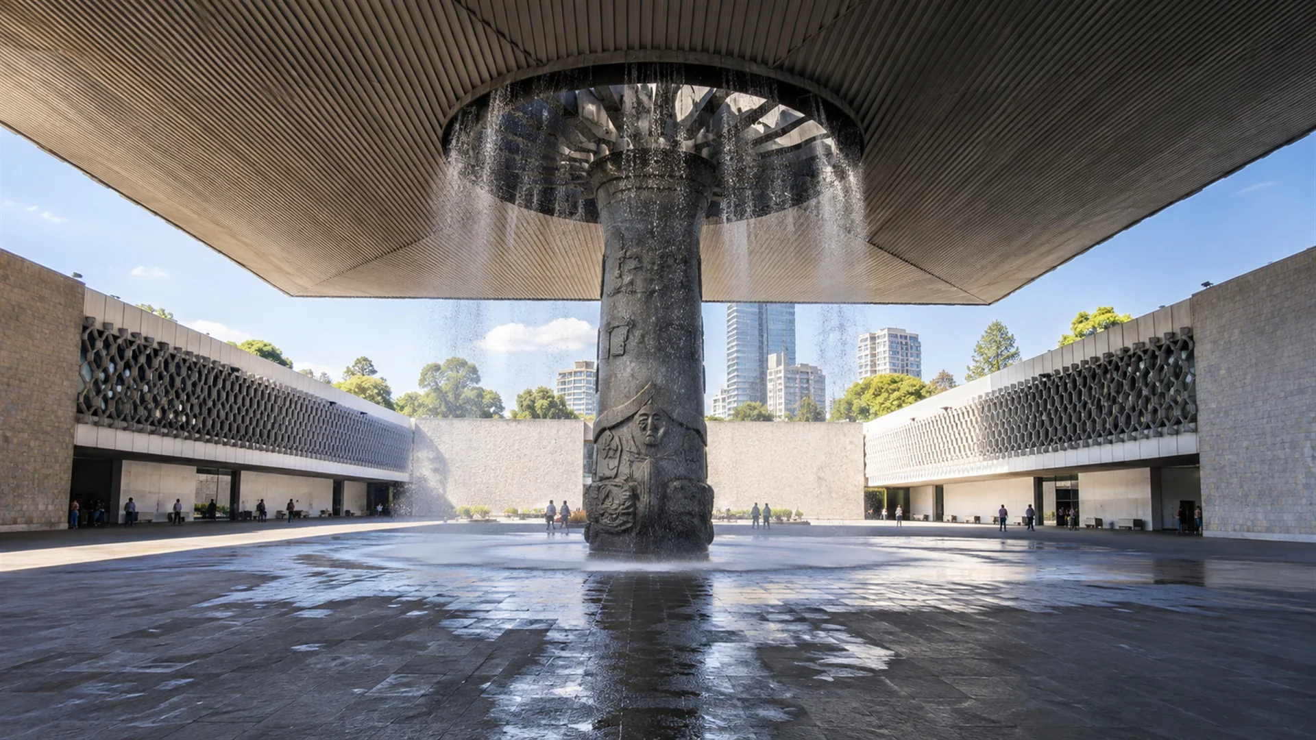 Central courtyard of the Museo Nacional de Antropologia in Mexico City with its large umbrella-shaped canopy and column fountain, modern architecture photography