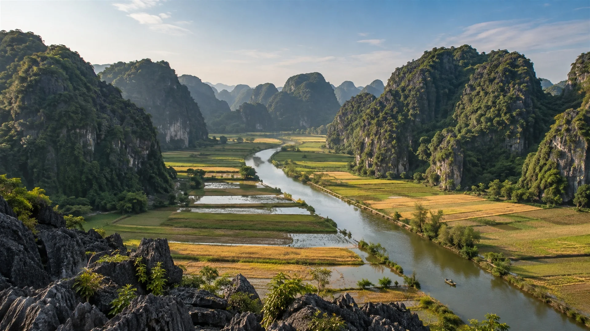 Best time to visit Vietnam — limestone karsts and a quiet river winding through rice fields in Ninh Binh, clear autumn light, travel photography