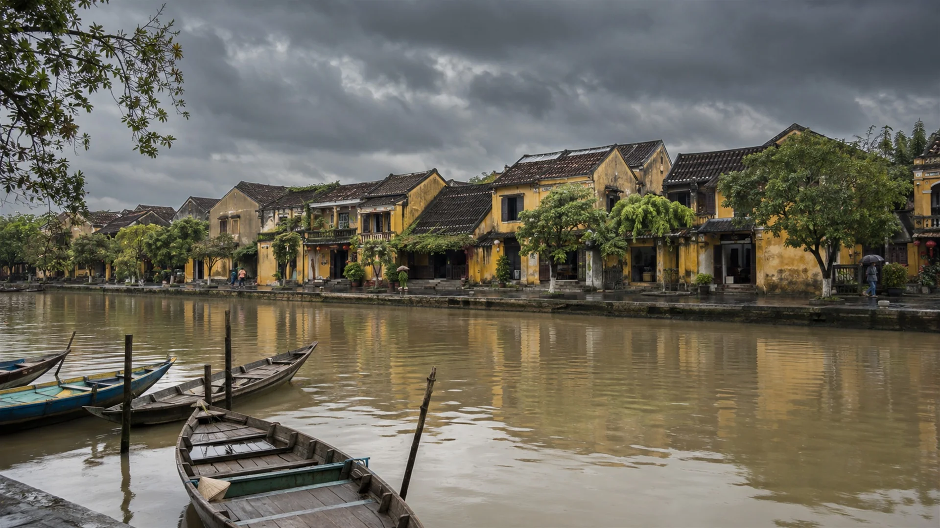 Heavy monsoon clouds over the Thu Bon river and old merchant houses of Hoi An in central Vietnam, wet autumn light, atmospheric travel photography