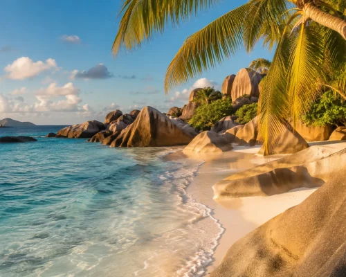 Anse Source d'Argent beach La Digue Seychelles with iconic granite boulders turquoise water and overhanging palm trees, golde